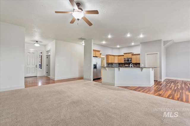1280 W Bacall St, Meridian, ID 83646 - unfurnished living room with baseboards, visible vents, and light colored carpet