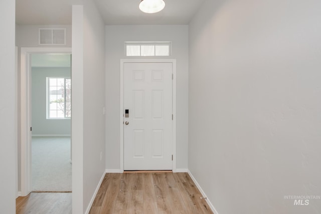 doorway with light wood-type flooring