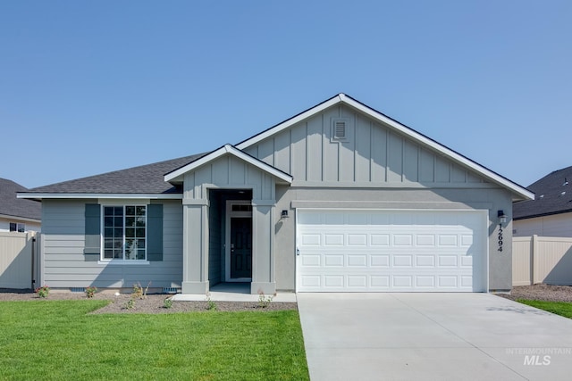 view of front of home featuring a garage and a front lawn