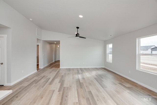 unfurnished living room featuring lofted ceiling, ceiling fan, and light wood-type flooring