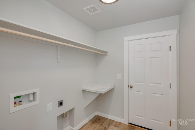 laundry area with hookup for a washing machine, light hardwood / wood-style flooring, and hookup for an electric dryer