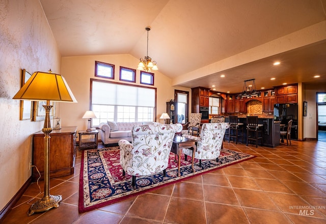186 Ridgeview Dr, Grangeville, ID 83530 - living area with a textured wall, dark tile patterned floors, a notable chandelier, and vaulted ceiling