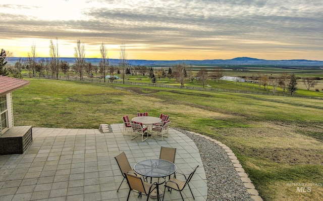 186 Ridgeview Dr, Grangeville, ID 83530 - view of patio / terrace featuring a rural view, a mountain view, outdoor dining area, and fence