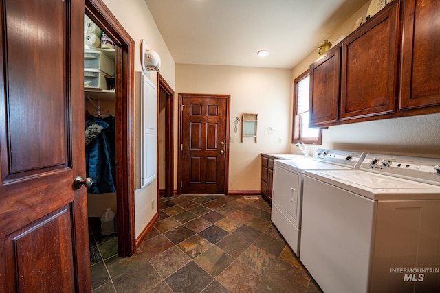 186 Ridgeview Dr, Grangeville, ID 83530 - washroom featuring stone finish flooring, a sink, baseboards, cabinet space, and washer and clothes dryer