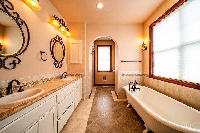 186 Ridgeview Dr, Grangeville, ID 83530 - bathroom with tile patterned floors, a soaking tub, double vanity, and a sink
