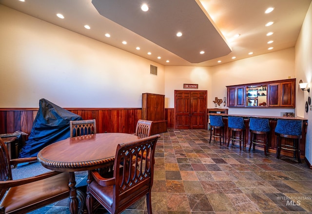 186 Ridgeview Dr, Grangeville, ID 83530 - dining space featuring wood walls, recessed lighting, visible vents, and a wainscoted wall