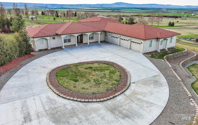 186 Ridgeview Dr, Grangeville, ID 83530 - view of front of home featuring concrete driveway, a front yard, a mountain view, and an attached garage