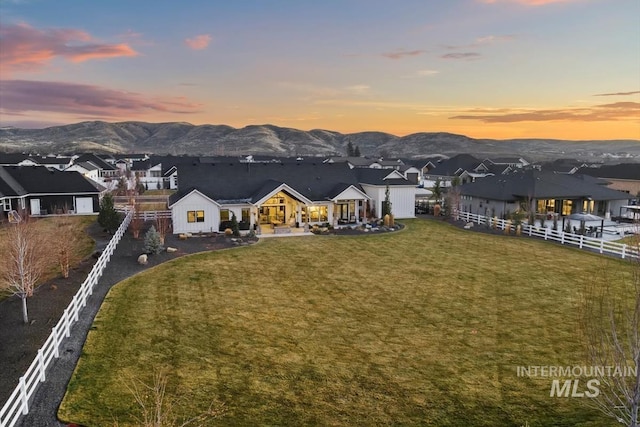 exterior space featuring a mountain view and a lawn