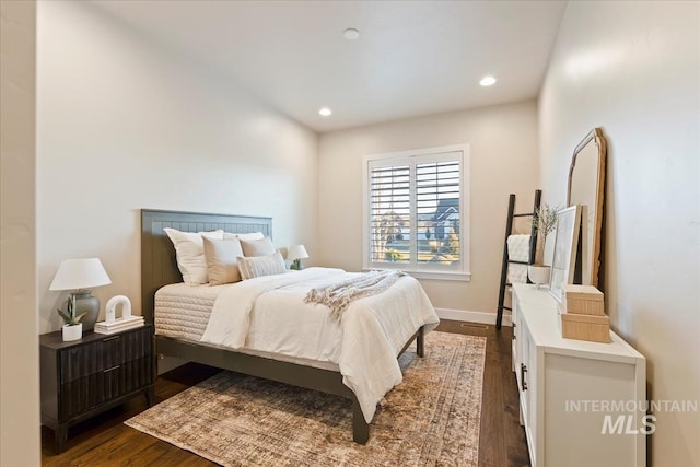 bedroom with dark wood-type flooring