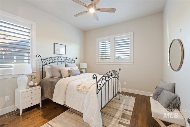 bedroom with ceiling fan and dark wood-type flooring