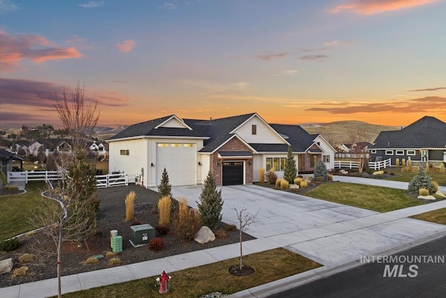 view of front of home with a garage, a yard, and a mountain view