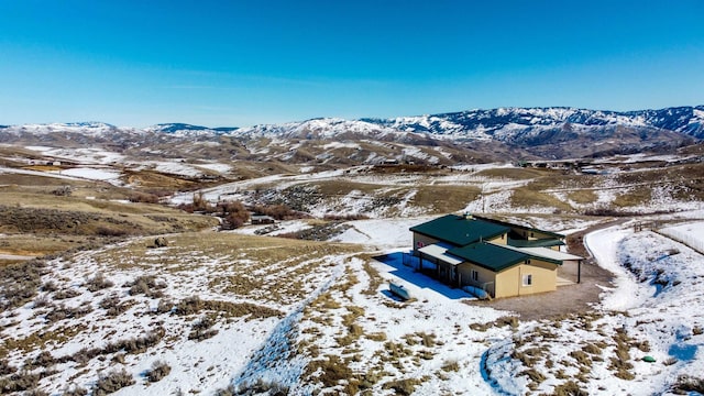 snowy aerial view with a mountain view