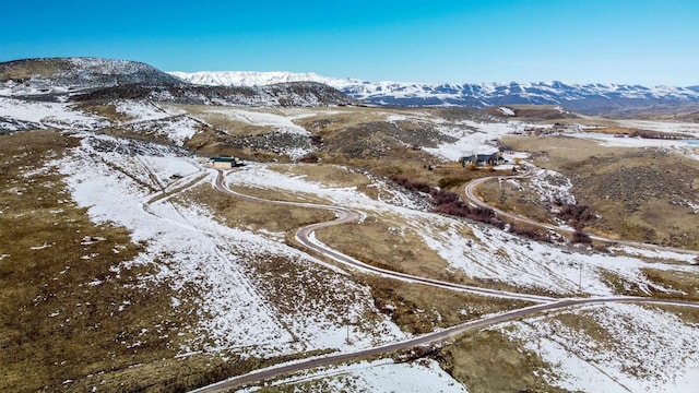 snowy aerial view featuring a mountain view