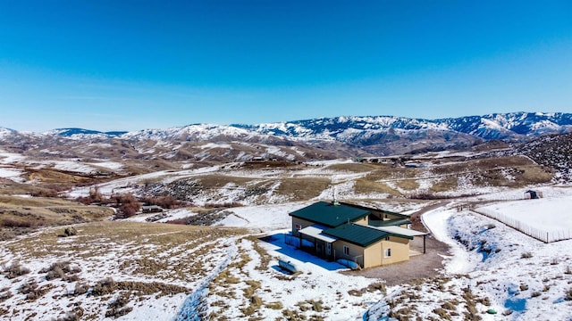 snowy aerial view with a mountain view