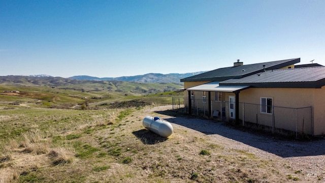 view of yard featuring a mountain view and fence
