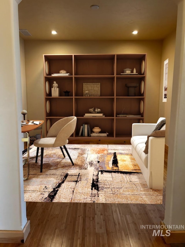 living area featuring wood finished floors, visible vents, and recessed lighting