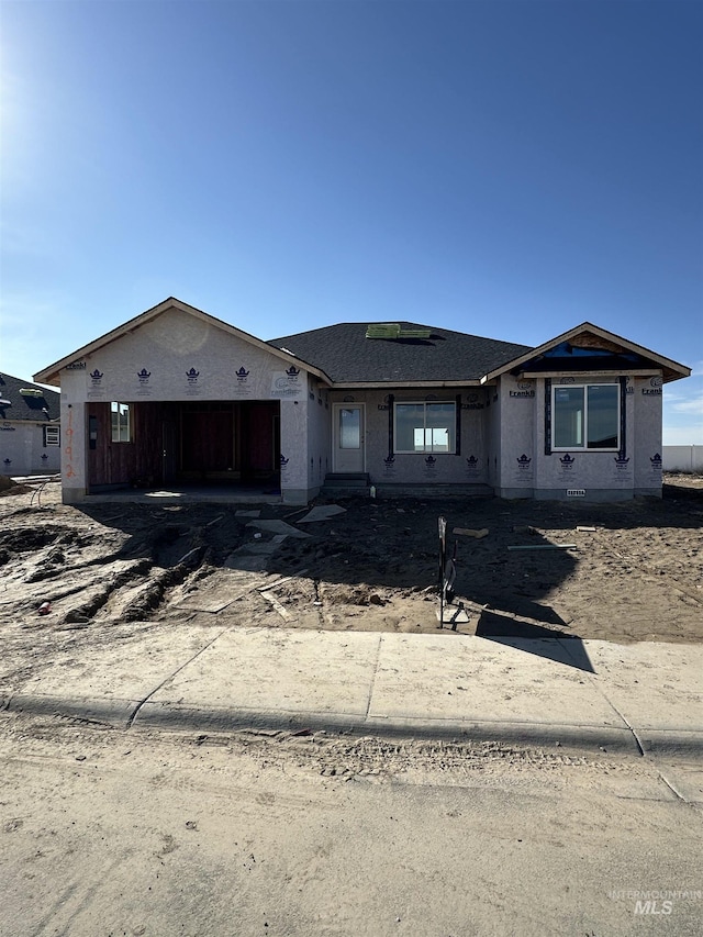 property in mid-construction with a garage and driveway