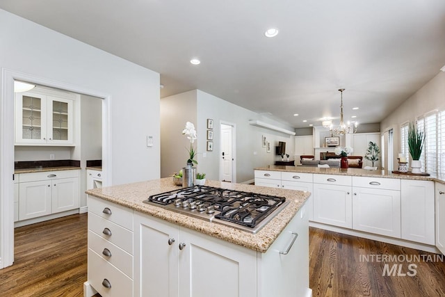 2417 E Brigantine Ct, Eagle, ID 83616 - kitchen with stainless steel gas stovetop, dark wood-style flooring, open floor plan, white cabinets, and recessed lighting