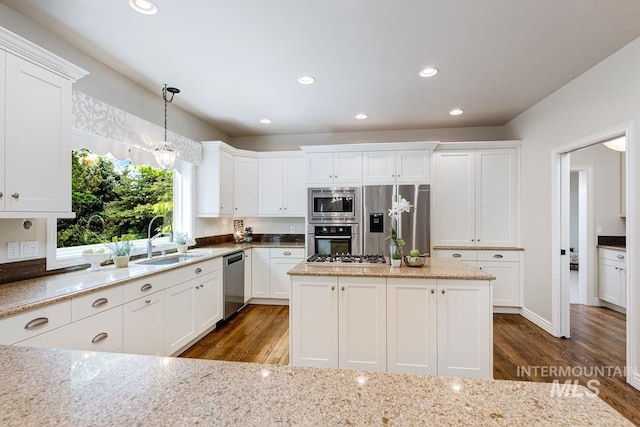 2417 E Brigantine Ct, Eagle, ID 83616 - kitchen featuring stainless steel appliances, dark wood finished floors, a sink, white cabinetry, and light stone countertops