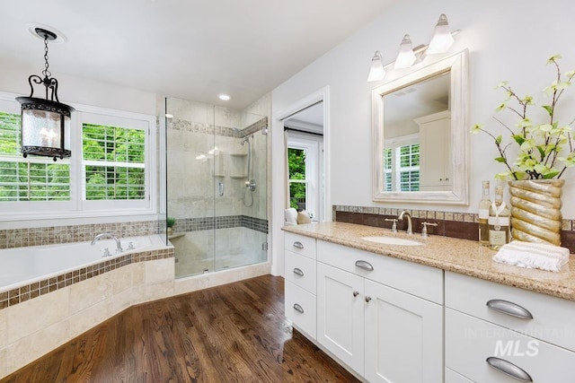 2417 E Brigantine Ct, Eagle, ID 83616 - bathroom with a shower stall, wood finished floors, vanity, and a garden tub