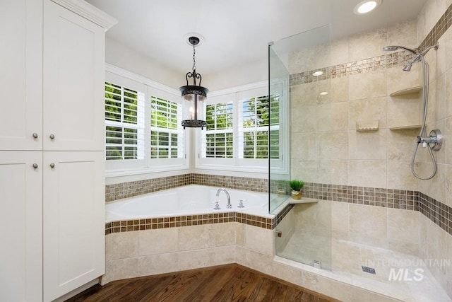 2417 E Brigantine Ct, Eagle, ID 83616 - bathroom with a stall shower, a garden tub, and wood finished floors