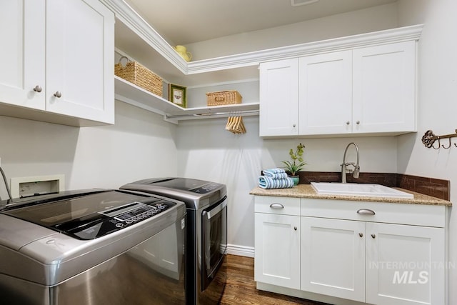 2417 E Brigantine Ct, Eagle, ID 83616 - clothes washing area with washer and clothes dryer, cabinet space, and wood finished floors