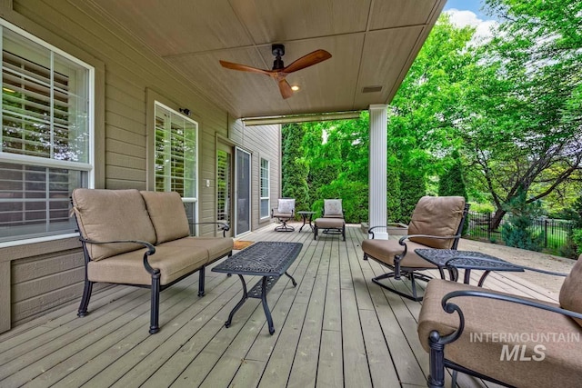 2417 E Brigantine Ct, Eagle, ID 83616 - wooden deck with an outdoor hangout area, ceiling fan, and fence
