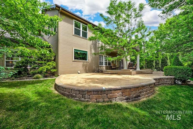 2417 E Brigantine Ct, Eagle, ID 83616 - rear view of house with a patio and a lawn
