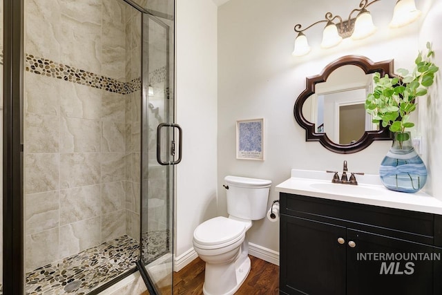2417 E Brigantine Ct, Eagle, ID 83616 - bathroom with a stall shower, wood finished floors, toilet, vanity, and baseboards