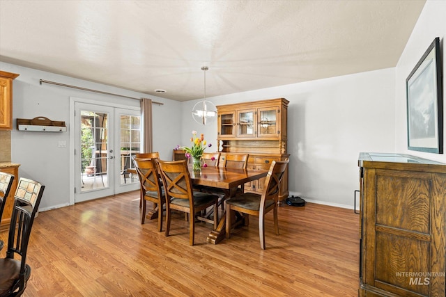 2023 E Wrightwood Dr, Meridian, ID 83642 - dining room featuring french doors, light wood-style flooring, baseboards, and a chandelier