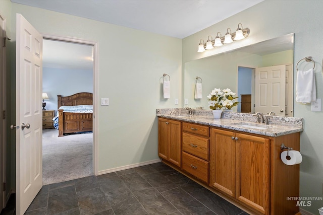 2023 E Wrightwood Dr, Meridian, ID 83642 - ensuite bathroom with double vanity, baseboards, and stone finish floors