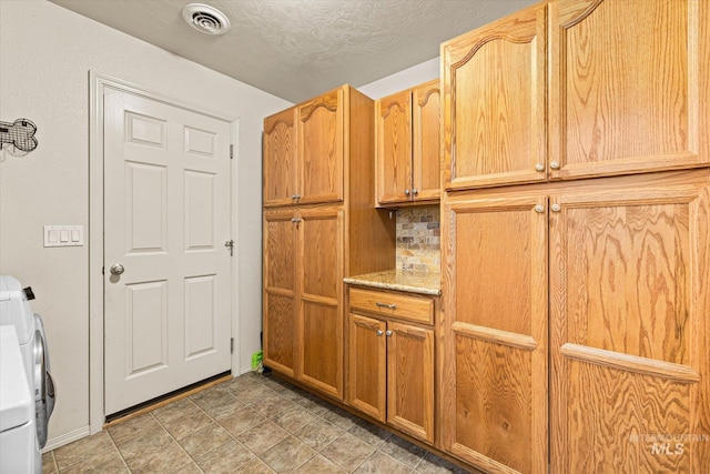 2023 E Wrightwood Dr, Meridian, ID 83642 - clothes washing area with separate washer and dryer, cabinet space, a textured ceiling, and baseboards