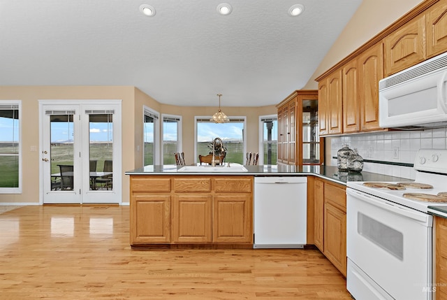 11610 W Lanktree Gulch Rd, Star, ID 83669 - kitchen with a peninsula, light wood finished floors, white appliances, tasteful backsplash, and a sink