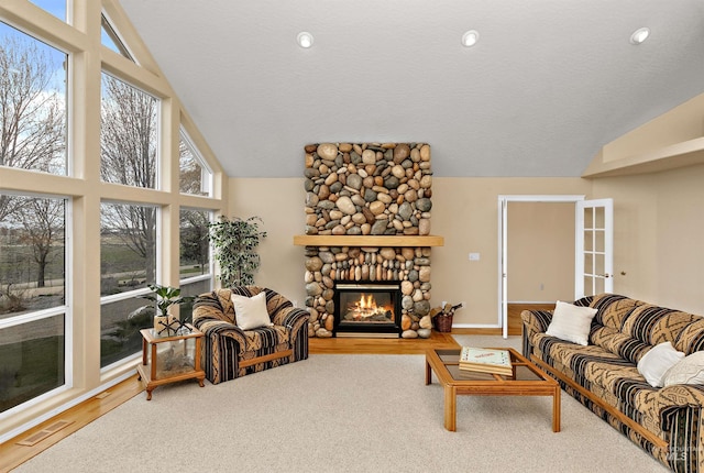 11610 W Lanktree Gulch Rd, Star, ID 83669 - living area with high vaulted ceiling, baseboards, visible vents, a stone fireplace, and wood finished floors