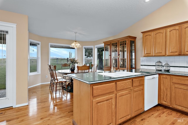 11610 W Lanktree Gulch Rd, Star, ID 83669 - kitchen featuring decorative backsplash, white dishwasher, a sink, and light wood finished floors