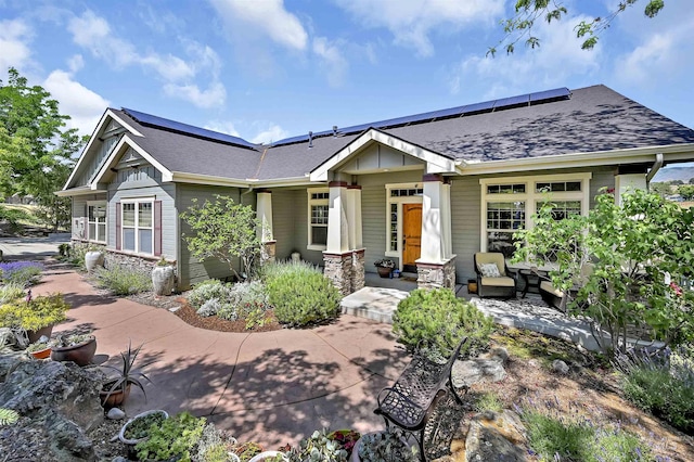 352 N Panorama Pl, Boise, ID 83702 - craftsman inspired home with roof mounted solar panels, board and batten siding, roof with shingles, and a porch