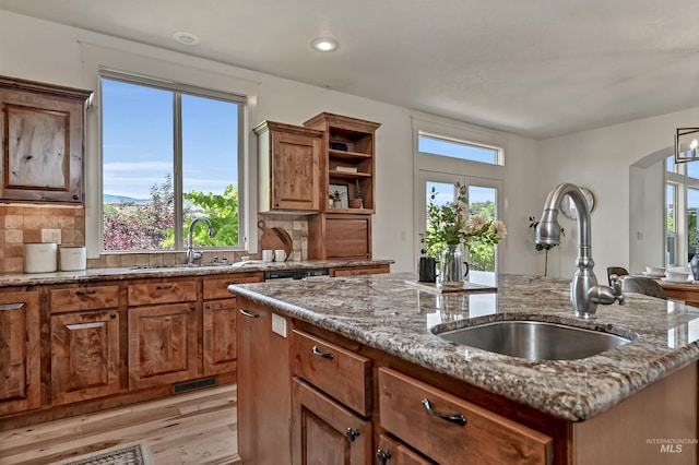 352 N Panorama Pl, Boise, ID 83702 - kitchen with a center island with sink, light stone counters, backsplash, and recessed lighting