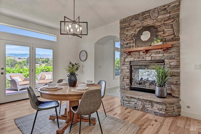 352 N Panorama Pl, Boise, ID 83702 - dining space featuring arched walkways, wood finished floors, a chandelier, and a fireplace