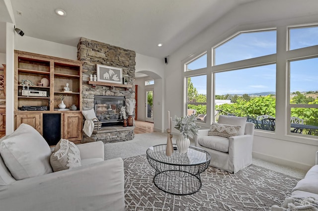 352 N Panorama Pl, Boise, ID 83702 - living area featuring arched walkways, healthy amount of natural light, light colored carpet, lofted ceiling, and recessed lighting
