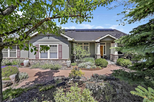 352 N Panorama Pl, Boise, ID 83702 - view of front of property with solar panels, stone siding, board and batten siding, and roof with shingles