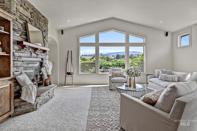 352 N Panorama Pl, Boise, ID 83702 - carpeted living room featuring a stone fireplace and vaulted ceiling