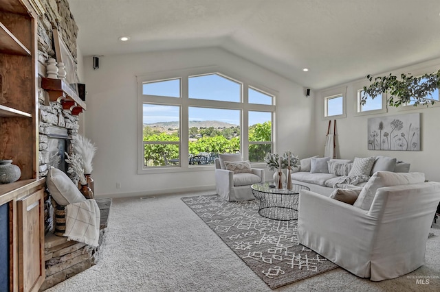 352 N Panorama Pl, Boise, ID 83702 - living area with carpet, a stone fireplace, vaulted ceiling, a mountain view, and recessed lighting