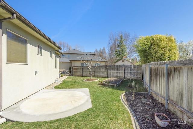 view of yard featuring a fenced backyard, a vegetable garden, and a patio