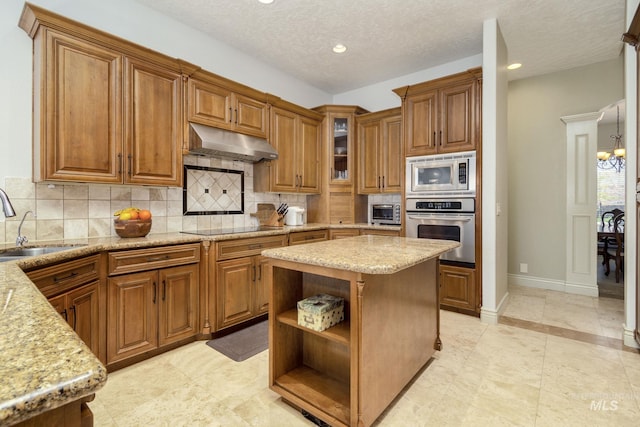 kitchen featuring open shelves, appliances with stainless steel finishes, brown cabinetry, and under cabinet range hood