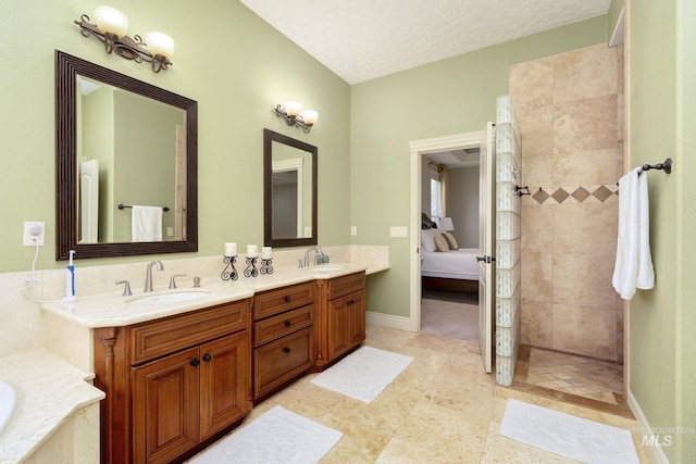 bathroom with double vanity, ensuite bath, a walk in shower, and a sink