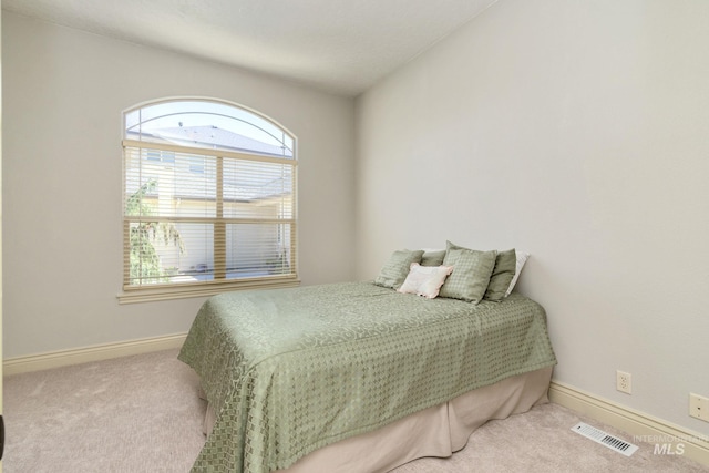 carpeted bedroom with baseboards and visible vents