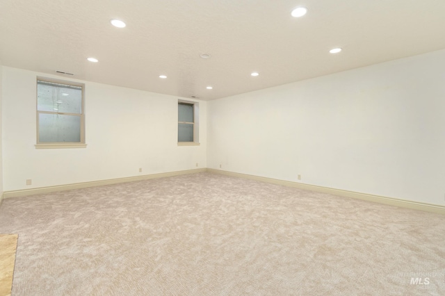 unfurnished room featuring visible vents, baseboards, carpet flooring, and recessed lighting