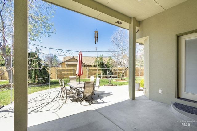 view of patio / terrace featuring outdoor dining area, a fenced backyard, and visible vents