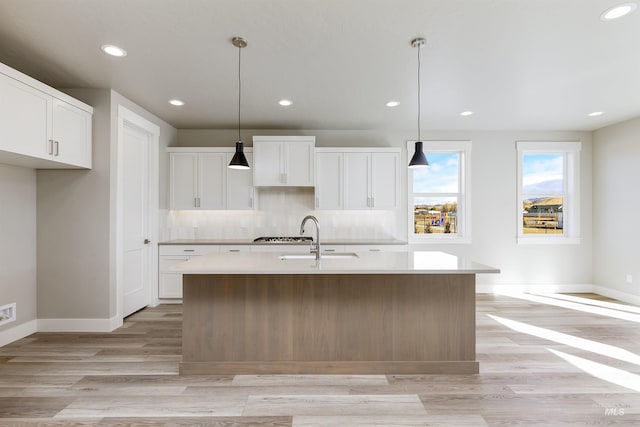 2330 E Monhegan Dr, Eagle, ID 83616 - kitchen with a sink, light wood finished floors, light countertops, baseboards, and recessed lighting