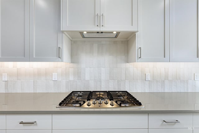 2330 E Monhegan Dr, Eagle, ID 83616 - kitchen with stainless steel gas stovetop, white cabinetry, light countertops, and decorative backsplash